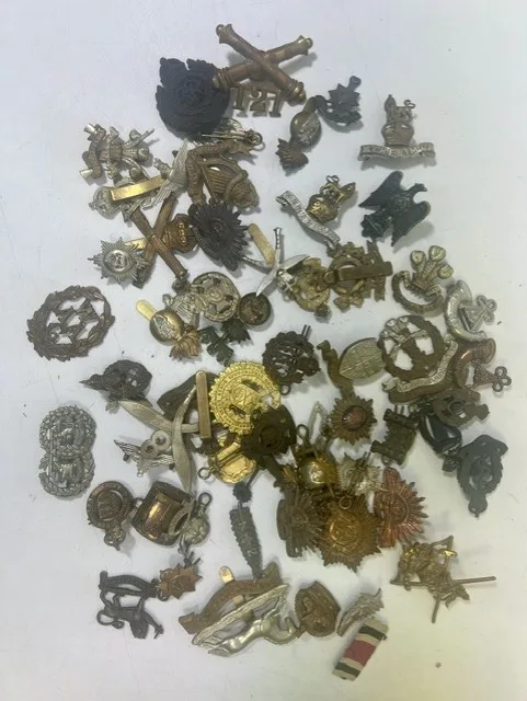 A large collection of early 20th century cap badges, collar badges and shoulder titles to include King's Own Hussars, British Woman's Army Auxiliary corps
