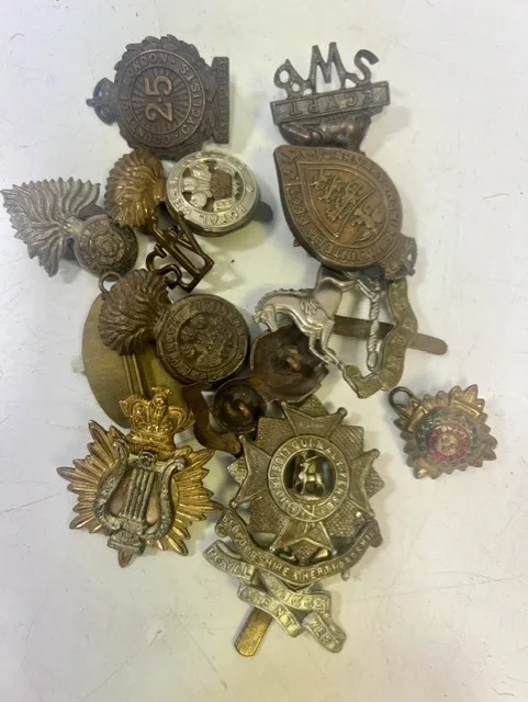 A large collection of early 20th century cap badges, collar badges and shoulder titles to include Royal West Kent, Bedfordshire & Hertfordshire