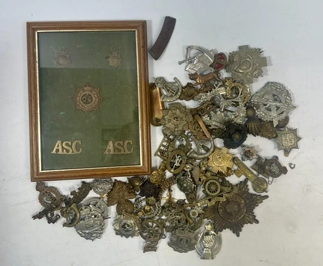 A large collection of early 20th century cap badges, collar badges and shoulder titles to include Yorks & Lancaster, Royal Artillery