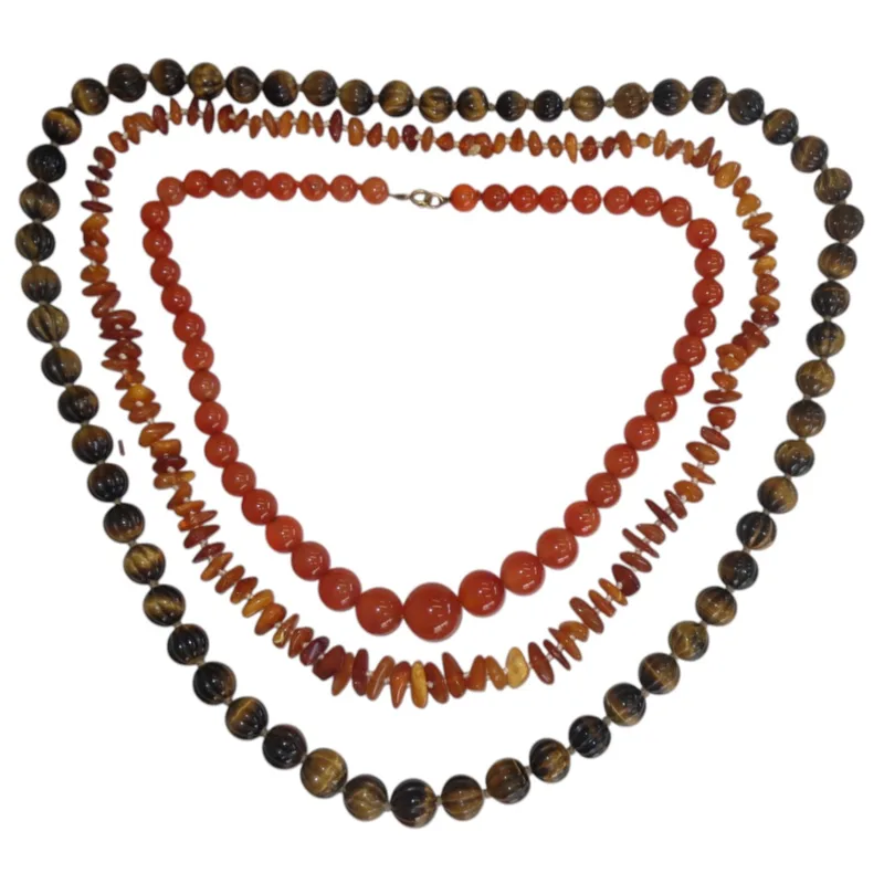 Three vintage beaded necklaces (3) melon carved tigers eye beads, a rough cut beaded amber necklace, and carnelian graduated oval beads