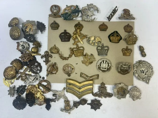 A large collection of early 20th century cap badges, collar badges and shoulder titles to include Lord Strathcona's Horse, The Queen's Regiment