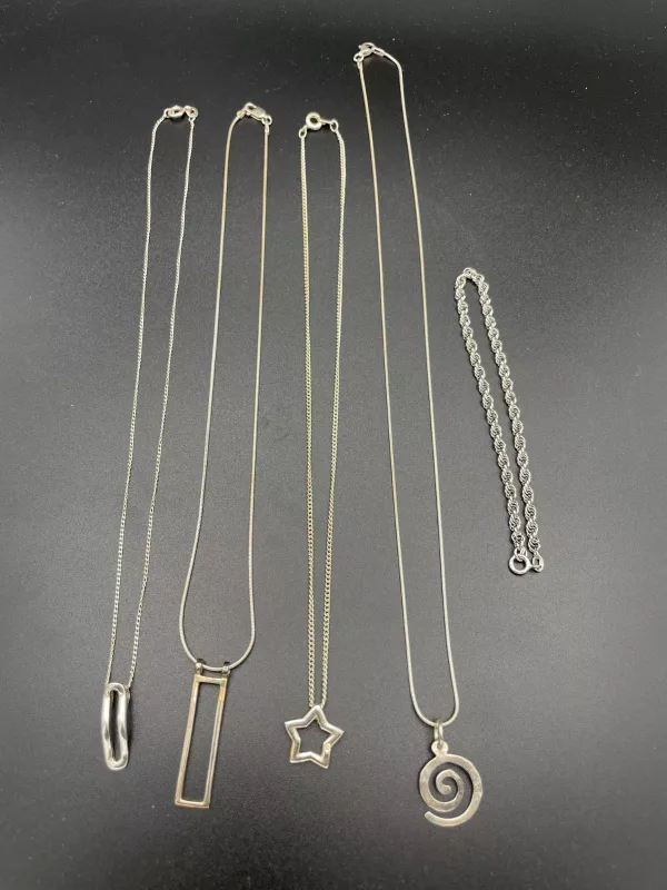 A Collection of Silver Toned Jewelry Including Necklaces and a Bracelet