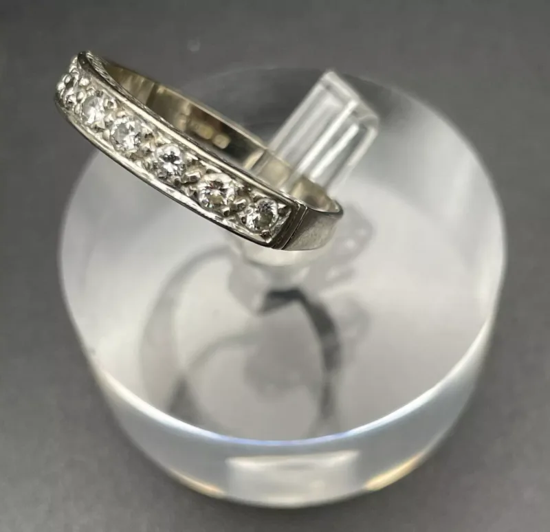 An 18 Carat White Gold and Seven Stone Diamond Eternity Ring