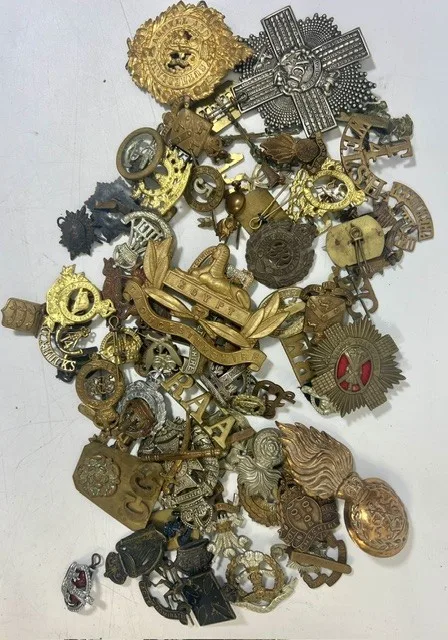 A large collection of early 20th century cap badges, collar badges and shoulder titles to include 92nd Gordon Highlanders, Royal regiment of Fusiliers