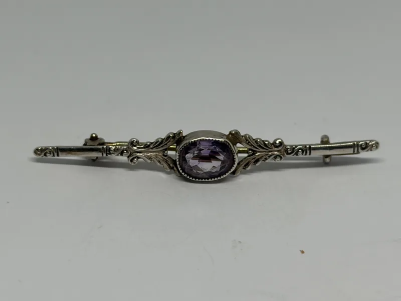 A Silver and Amethyst Pin Brooch