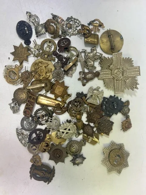 A large collection of early 20th century cap badges, collar badges and shoulder titles to include Barrow & North London training corps, Home Frontier force