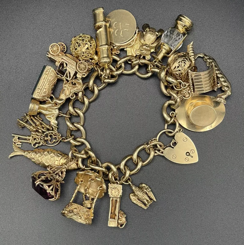 9 Karat Yellow Gold Curb Link Charm Bracelet with Heart Padlock Clasp and Assorted Charms