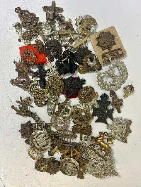 A large collection of early 20th century cap badges, collar badges and shoulder titles to include RAF, Argyll & Sutherland, Herefordshire, Northamptonshire